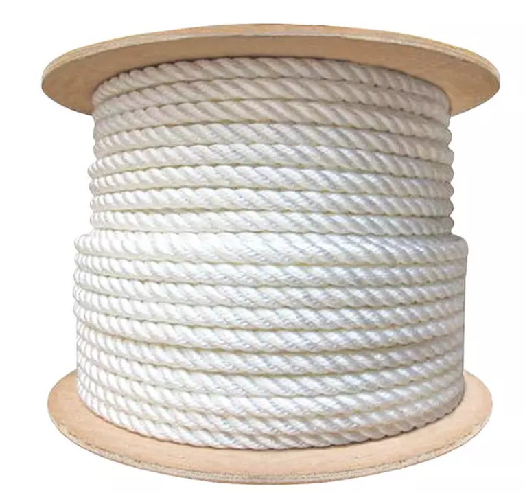 A coil of nylon rope lying on a wooden surface, emphasizing its flexibility and high tensile strength for heavy-duty tasks.